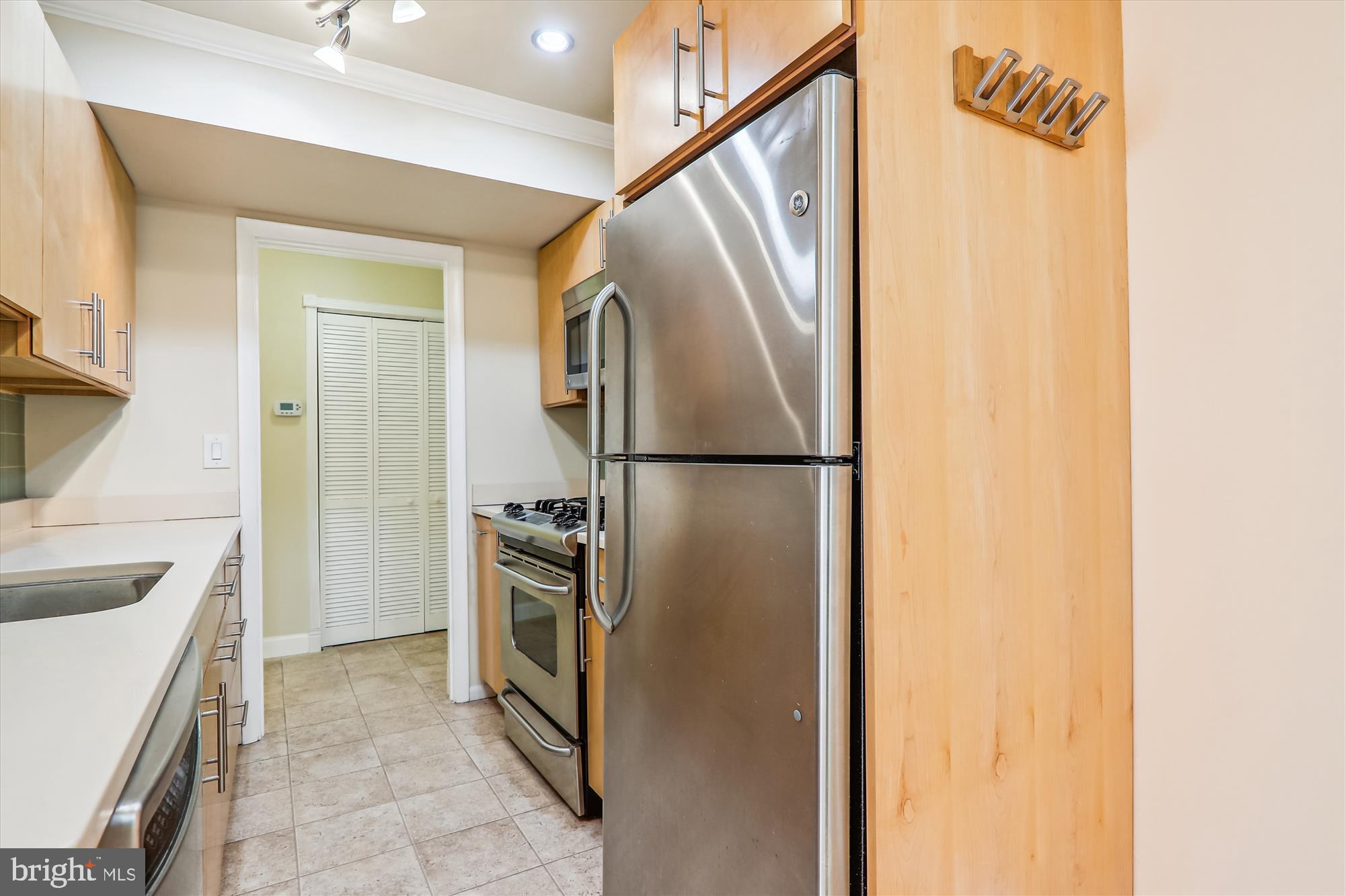 4970 Battery Lane, Unit 408 Bethesda, MD 20814 - Photo 15 of 40 a kitchen with a refrigerator and a sink