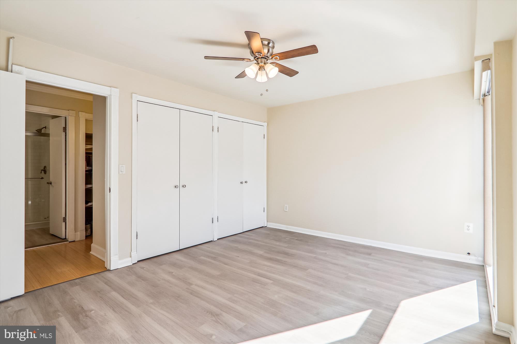 4970 Battery Lane, Unit 408 Bethesda, MD 20814 - Photo 20 of 40 a view of a room with wooden floor and a ceiling fan