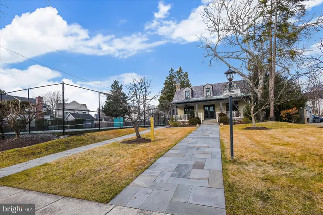 a front view of a house with a yard and outdoor seating