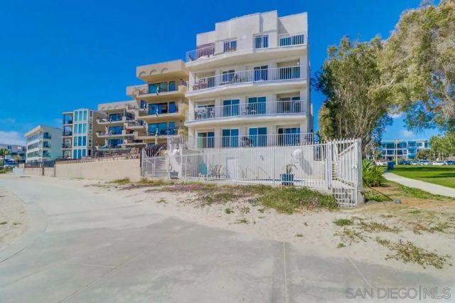 a front view of a house with garden and plants