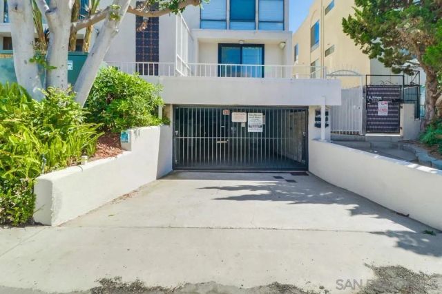 a view of a lake with beach and trees in the background