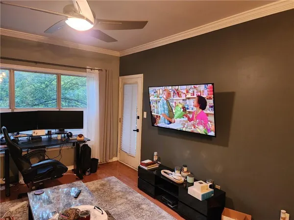 a bedroom with furniture and a flat screen tv
