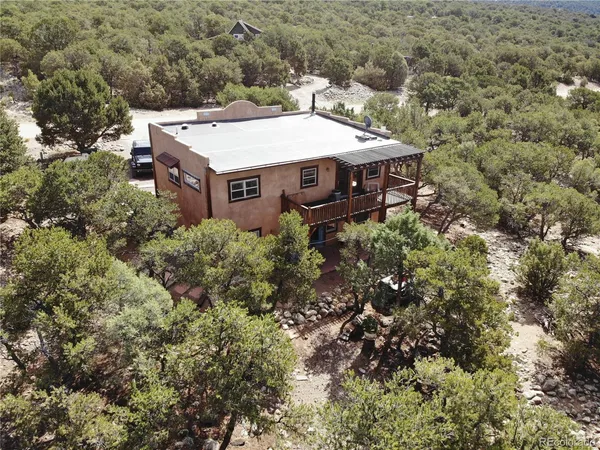 an aerial view of a house with a yard
