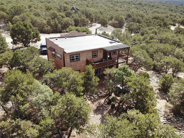 an aerial view of a house with a yard