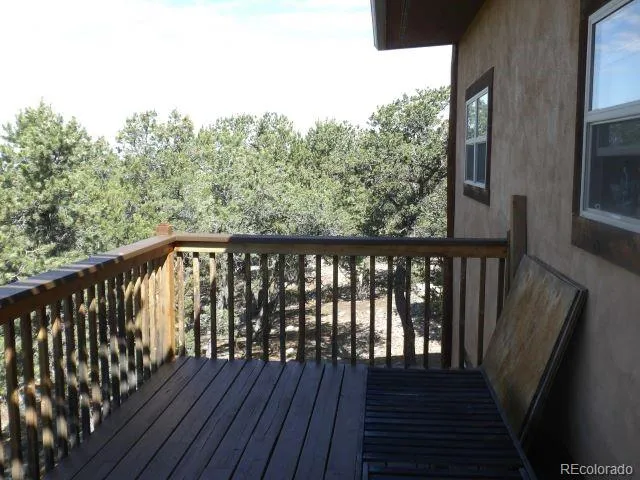 a balcony with wooden floor and fence