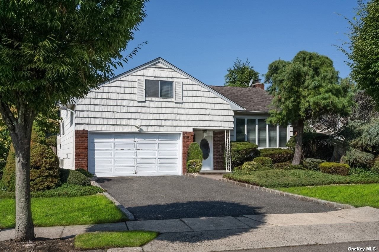112 Roxton Road Plainview, NY 11803 - Photo 1 of 1 a front view of a house with a yard and garage