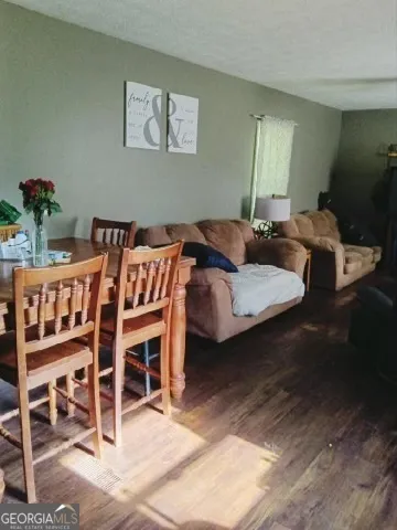 a bedroom with furniture and a wooden floor