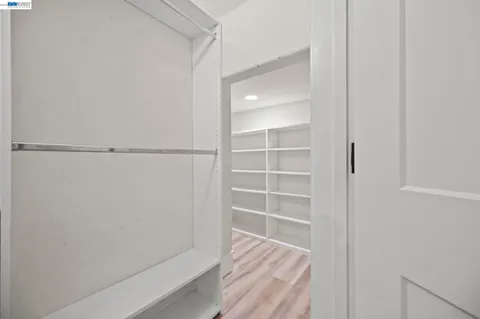 a view of walk in closet with empty racks