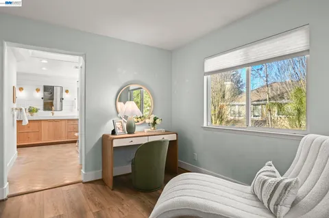 a view of a livingroom with furniture window and wooden floor