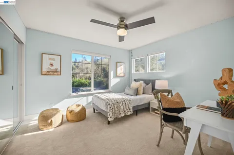 a spacious bedroom with a bed and window