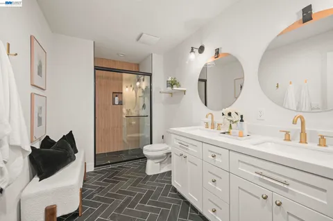 a en suite bathroom with a double vanity sink a mirror and a shower