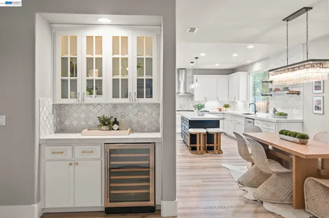 a kitchen with white cabinets and appliances