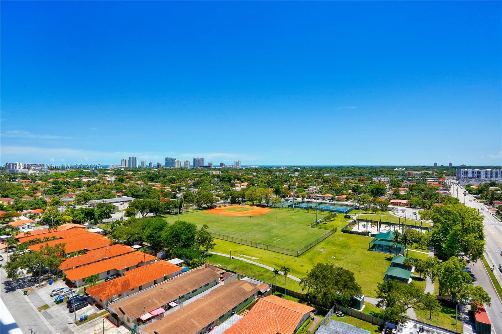 an aerial view of residential houses with outdoor space