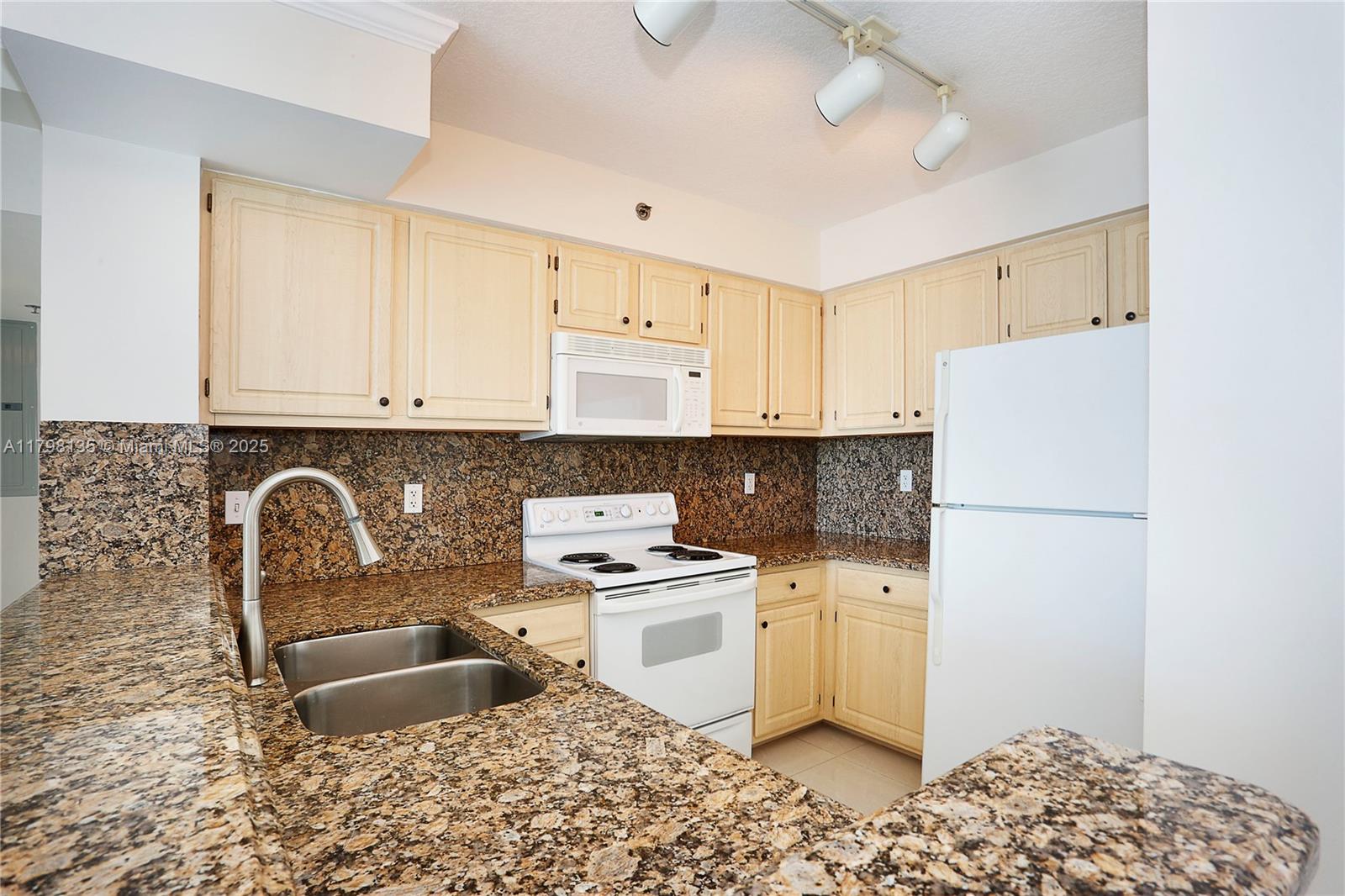 2665 Southwest 37th Avenue, Unit 1506 Miami, FL 33133 - Photo 3 of 19 a kitchen with stainless steel appliances granite countertop a sink stove and refrigerator
