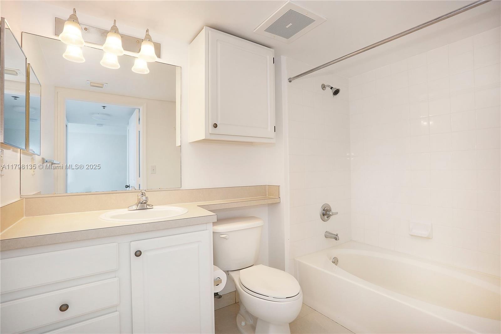 2665 Southwest 37th Avenue, Unit 1506 Miami, FL 33133 - Photo 7 of 19 a bathroom with a sink a toilet and shower