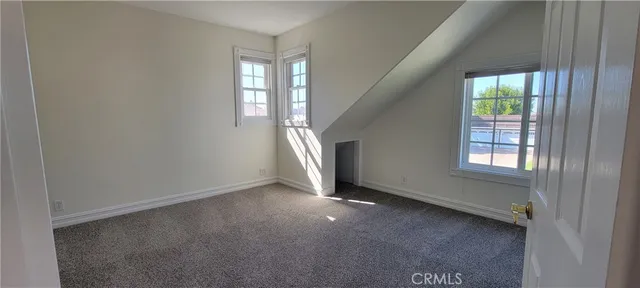 a view of staircase with lots of frames on wall and stairs