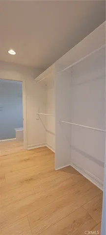 a spacious bathroom with a vanity a sink a mirror and a bathtub