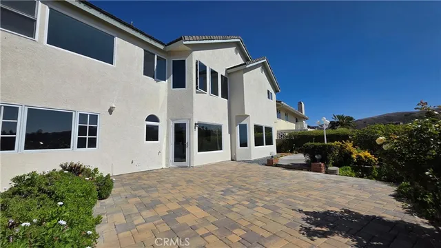 a kitchen with kitchen island granite countertop a sink cabinets and wooden floor
