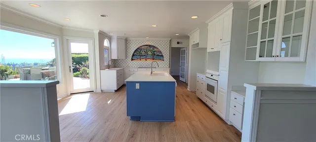 an empty room with fireplace wooden floor and windows
