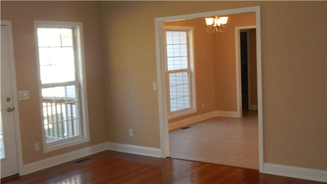 1205 East End Road Manchester, TN 37355 - Photo 2 of 14 Cozy living room with gas fireplace, hardwood flooring, and doors onto the back deck. Room also opens to the breakfast area in the kitchen.