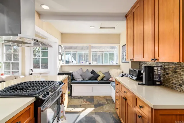 a kitchen with sink a stove and a window