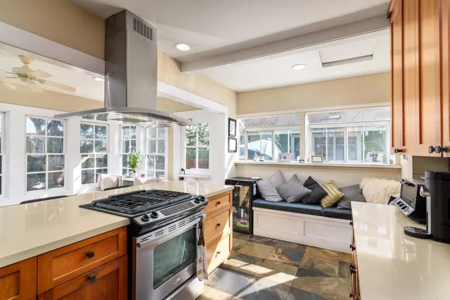 a kitchen with a stove and a large window