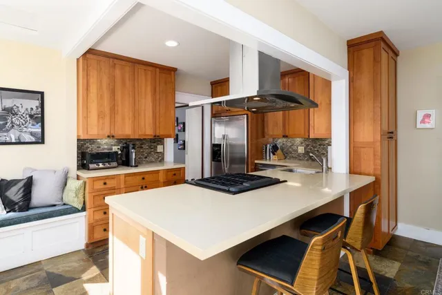 a kitchen with a sink a stove and a refrigerator