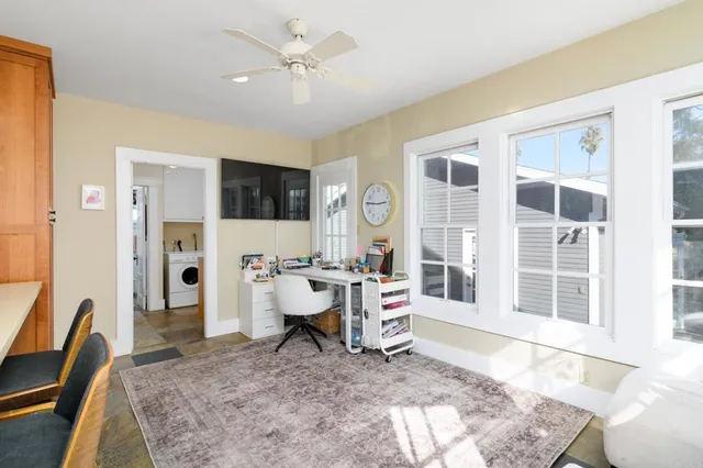 a living room with furniture a flat screen tv and a table