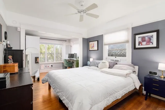 a bedroom with a bed and wooden floor