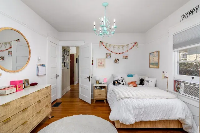 a bedroom with a bed tub and a large mirror on the dresser