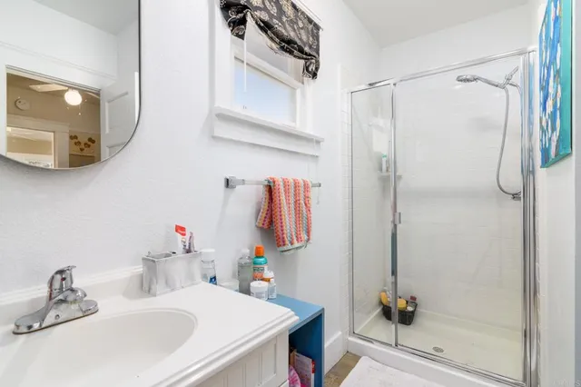 a bathroom with a sink vanity and a mirror