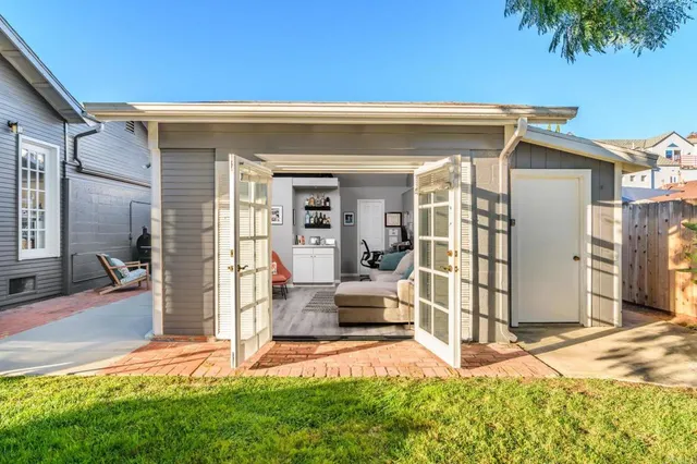 a view of a porch with furniture and a yard