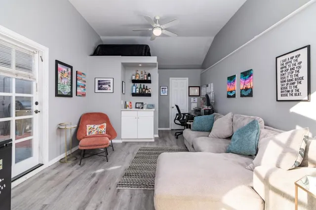 a living room with furniture a rug and a window