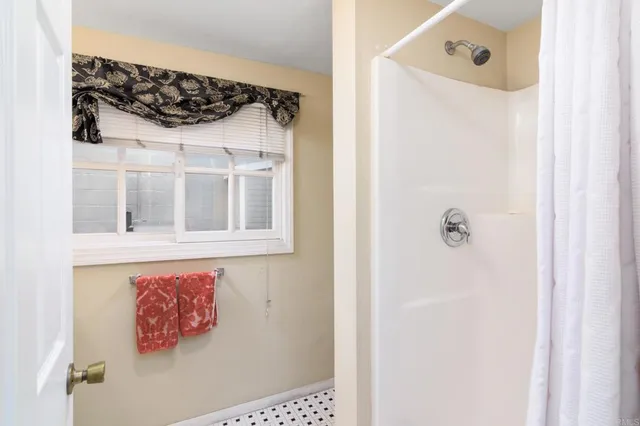 a bathroom with a shower and a sink