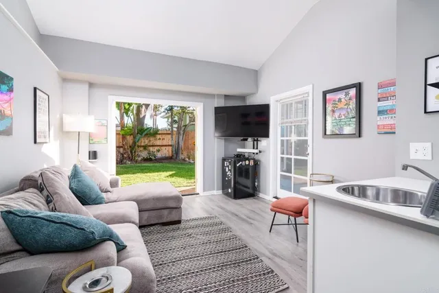 a living room with furniture a fireplace and a flat screen tv