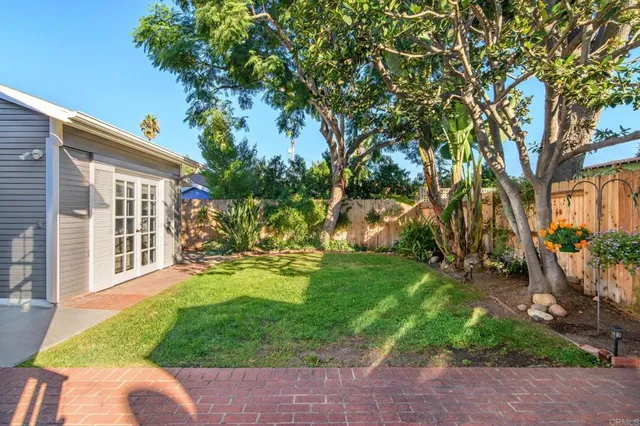 a view of a patio with table and chairs and potted plants
