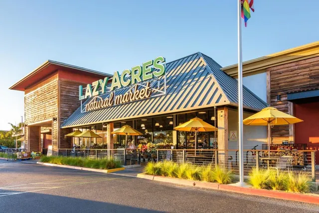 a view of a sign in front of a house with a big yard
