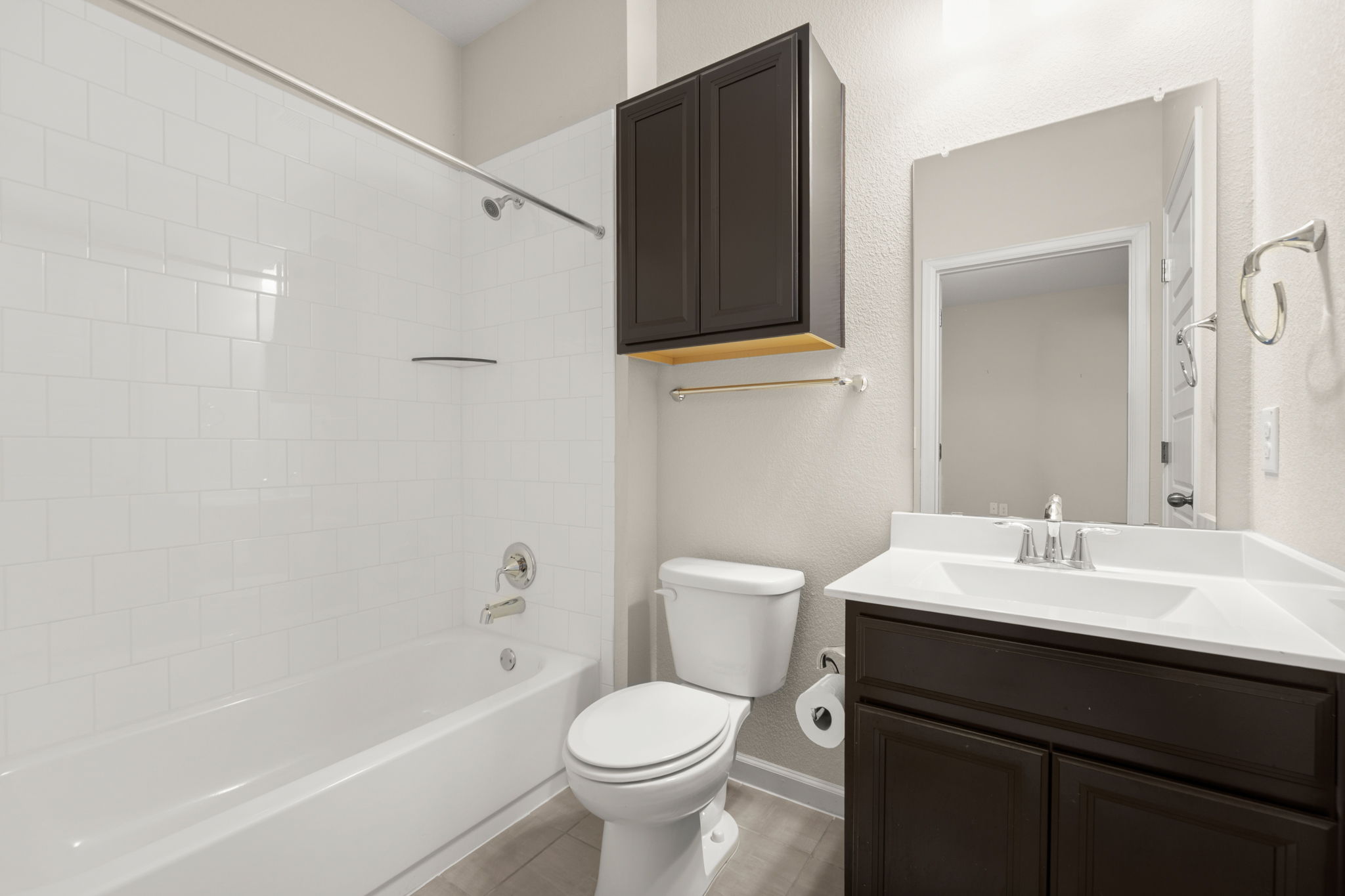 4403 Swift Path Austin, TX 78741 - Photo 23 of 32 Bathroom featuring a dark wood-finish vanity with an integrated white sink and countertop