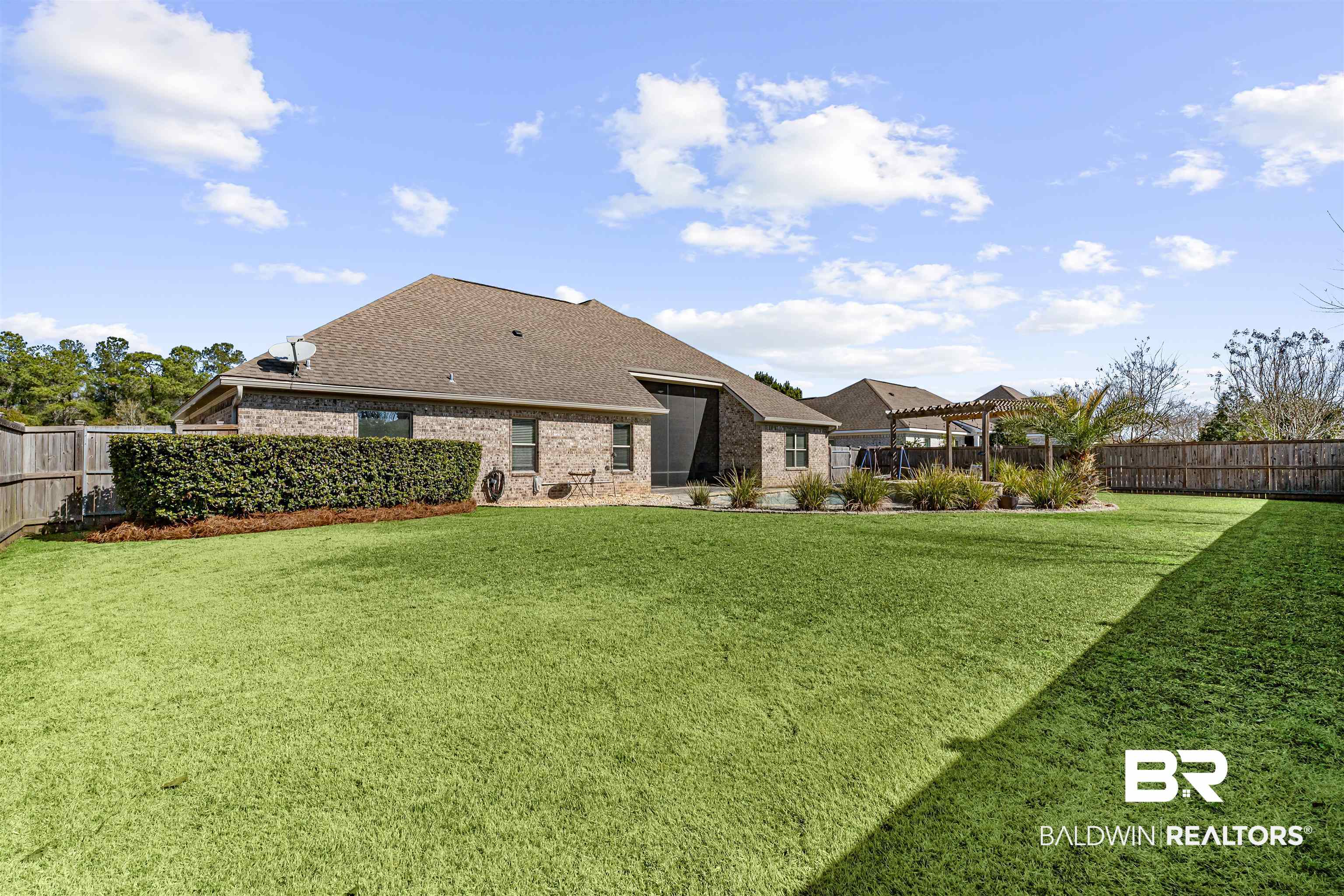 8844 Rosedown Lane Daphne, AL 36526 - Photo 24 of 24 Rear view of house with a fenced backyard, brick siding, and a shingled roof