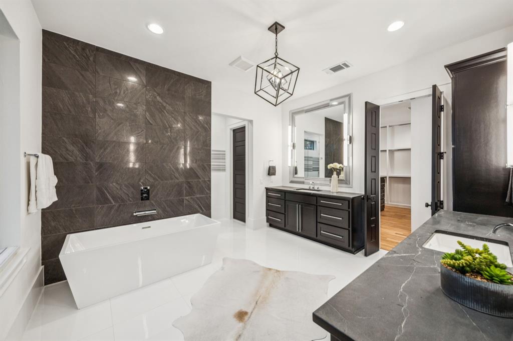 4330 Ridge Road Dallas, TX 75229 - Photo 17 of 30 a large bathroom with a sink a large mirror and a shower