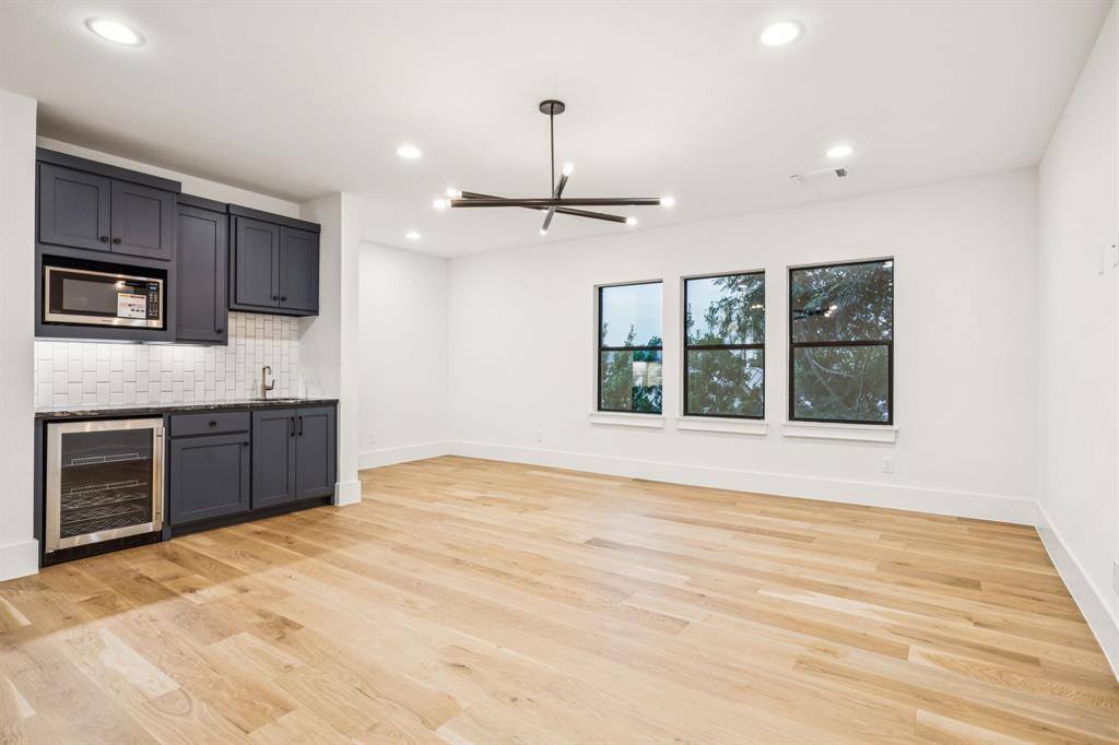 4330 Ridge Road Dallas, TX 75229 - Photo 22 of 30 a view of an empty room with a kitchen and a window