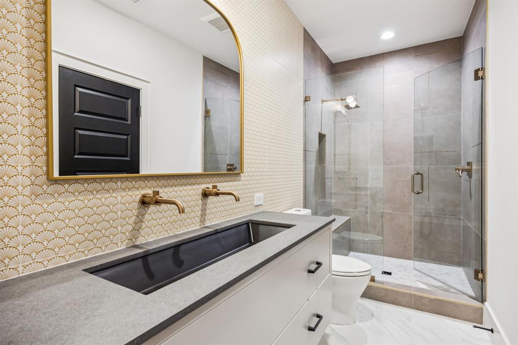 4330 Ridge Road Dallas, TX 75229 - Photo 23 of 30 a bathroom with a double vanity sink a toilet and shower