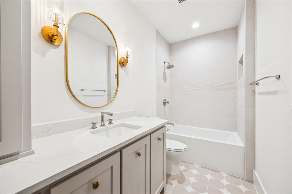 4330 Ridge Road Dallas, TX 75229 - Photo 26 of 30 a bathroom with a granite countertop sink a toilet and shower
