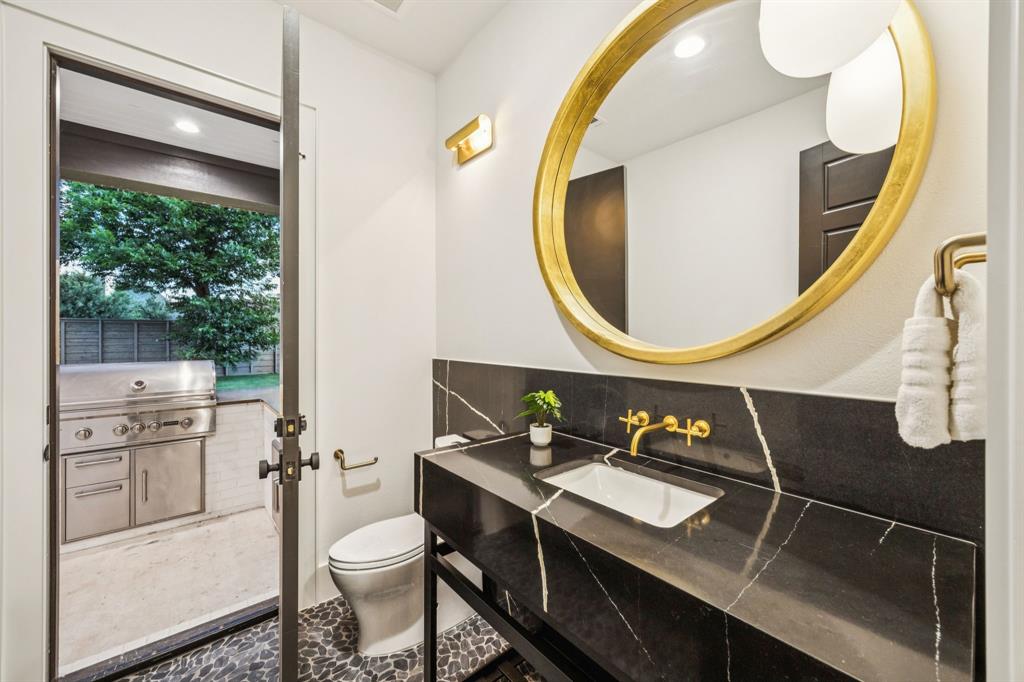 4330 Ridge Road Dallas, TX 75229 - Photo 28 of 30 a bathroom with a sink a toilet and a mirror