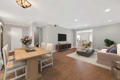 a dining room with furniture and wooden floor