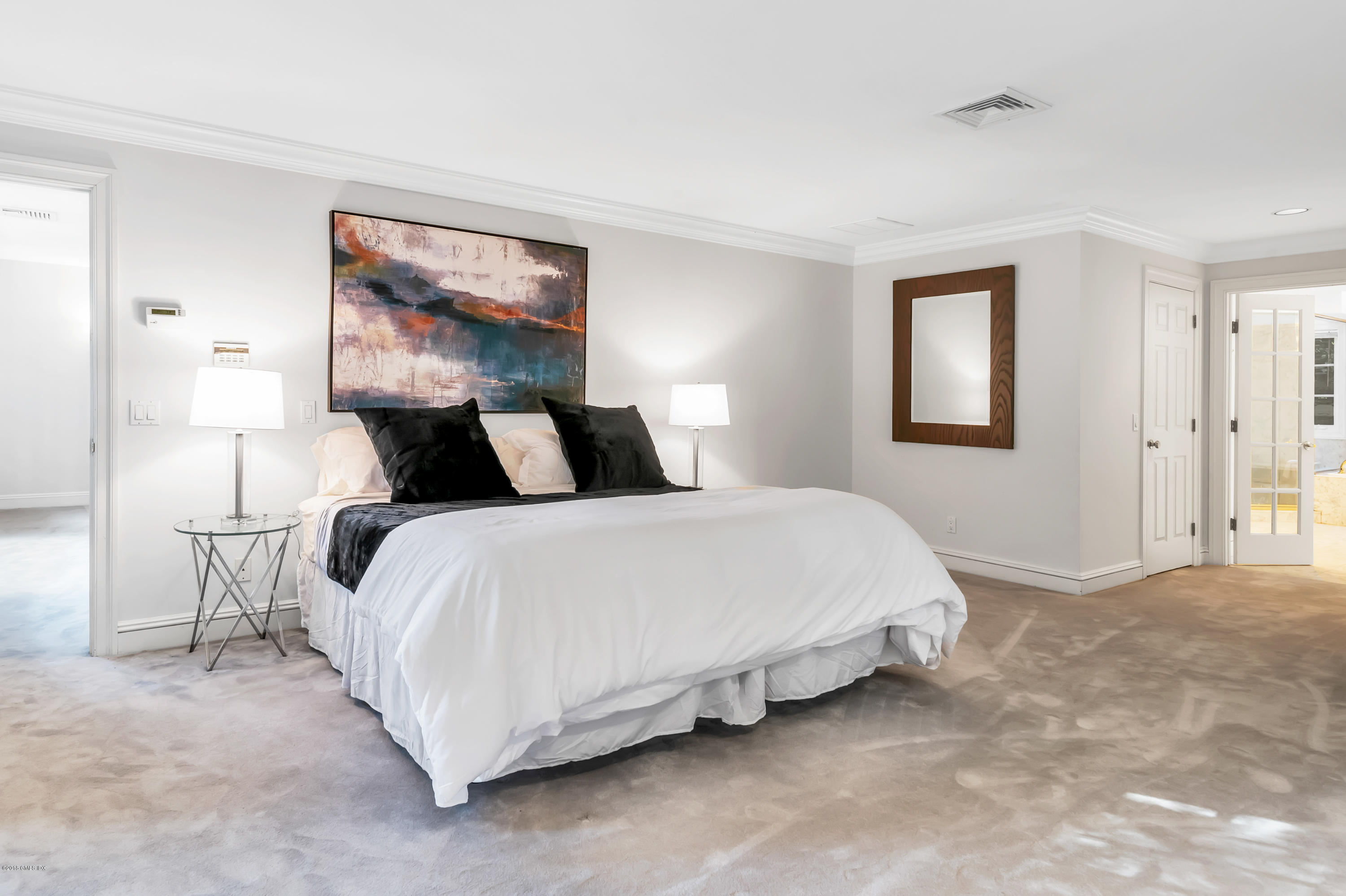 329 Stanwich Road Greenwich, CT 06830 - Photo 19 of 39 a bedroom with a bed and window