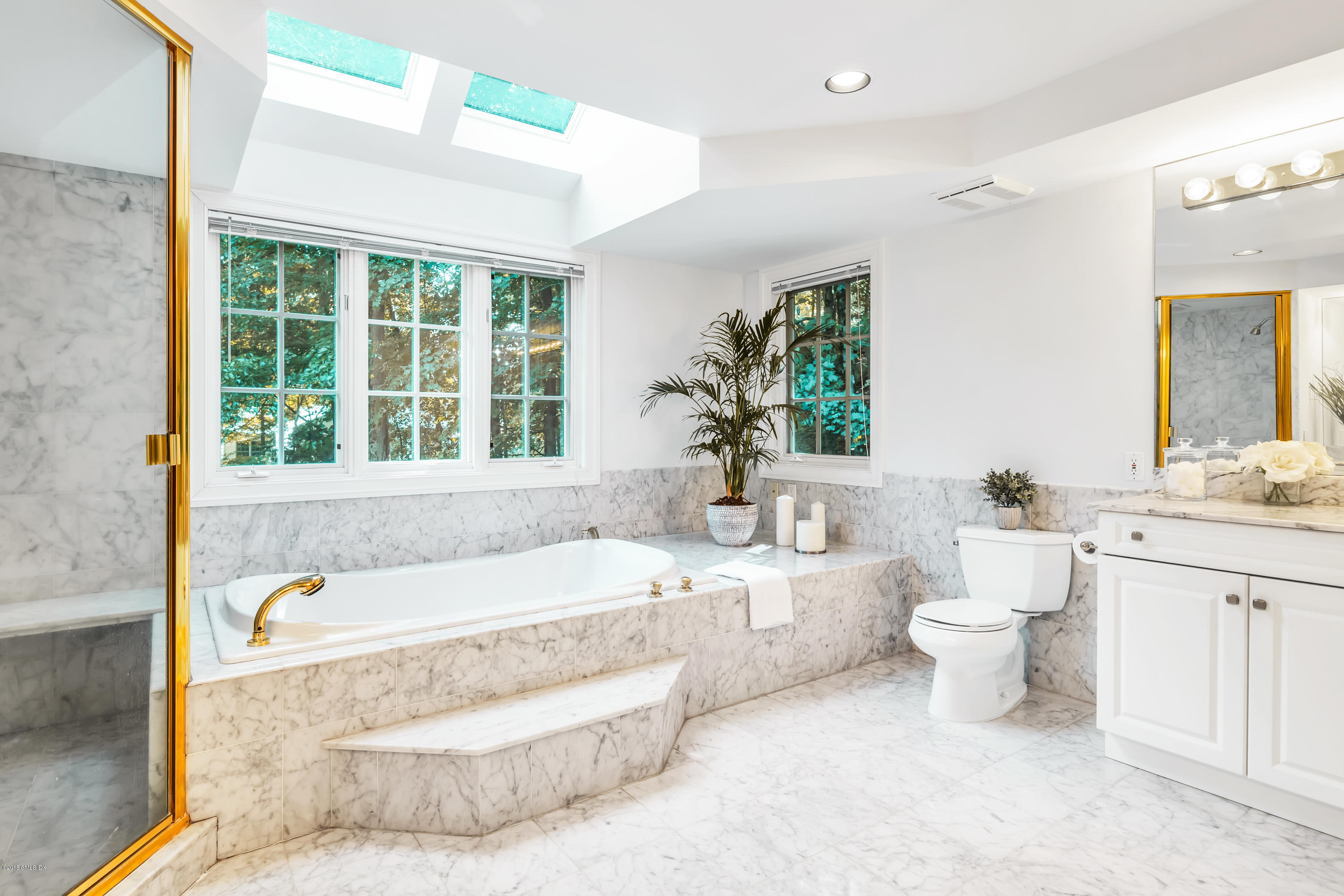 329 Stanwich Road Greenwich, CT 06830 - Photo 22 of 39 a bathroom with a tub a sink and a large mirror