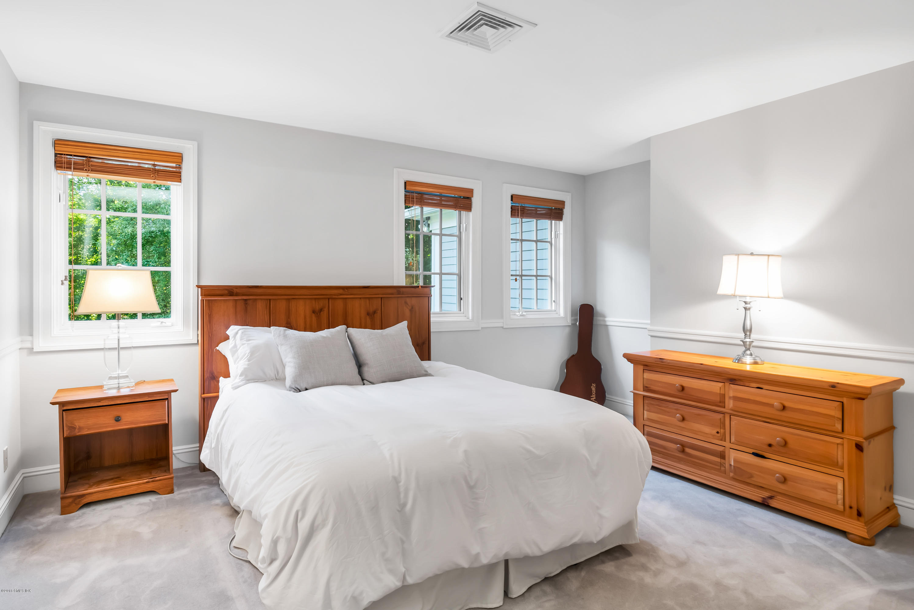 329 Stanwich Road Greenwich, CT 06830 - Photo 27 of 39 a bedroom with a bed and a dresser