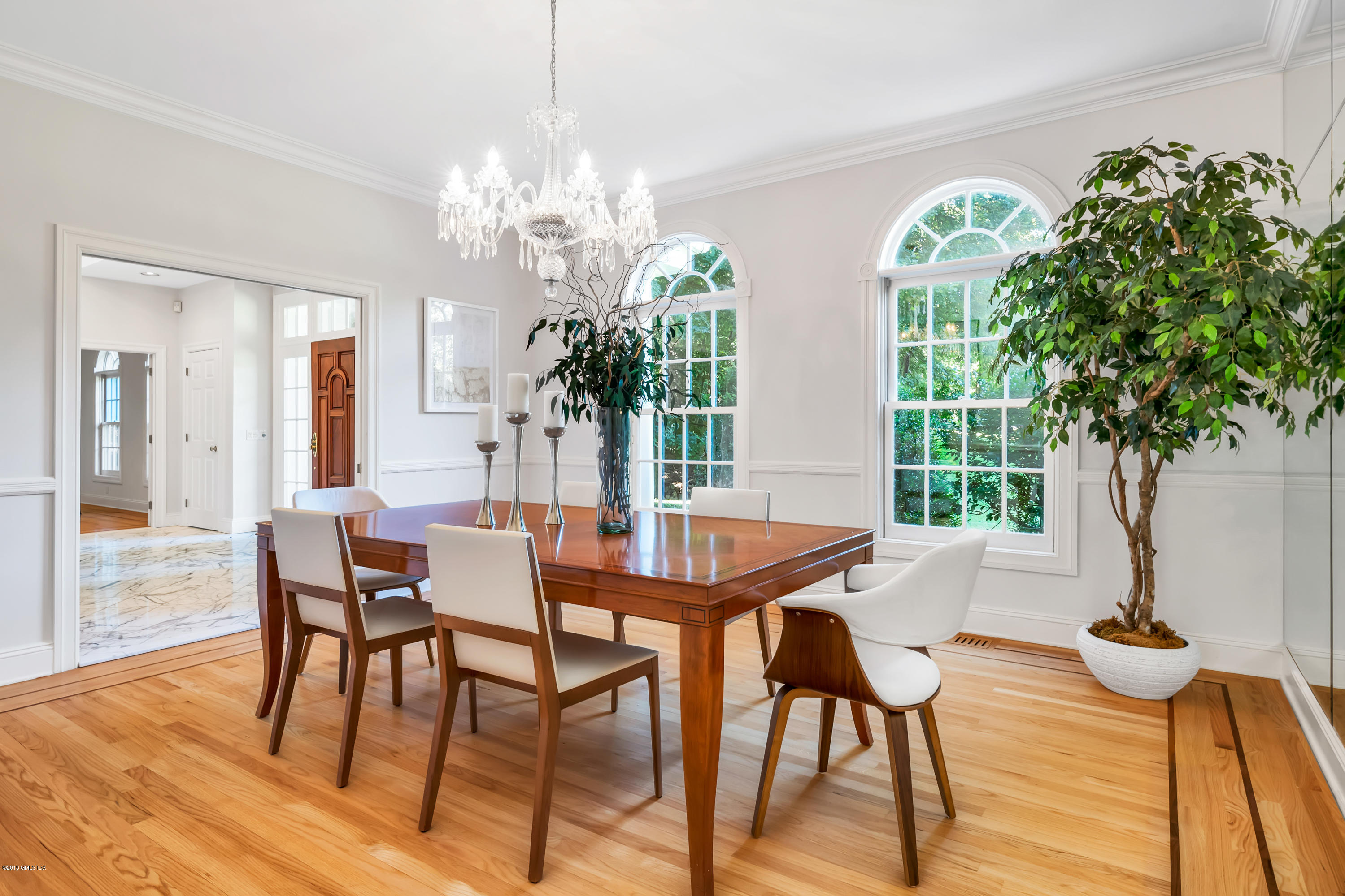 329 Stanwich Road Greenwich, CT 06830 - Photo 6 of 39 a dining room with furniture a chandelier and wooden floor