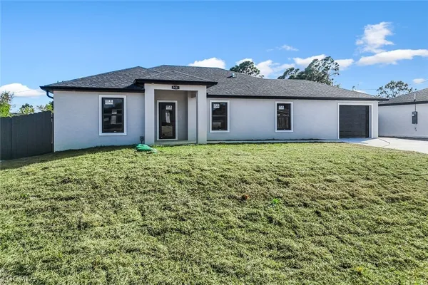 a front view of a house with a yard and garage